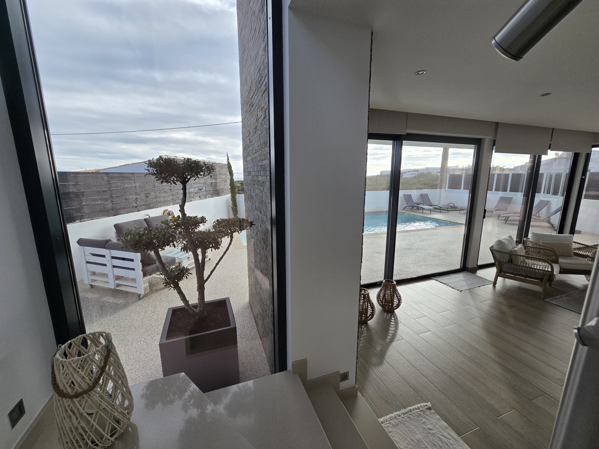 Villa living room entrance with pool view through large windows