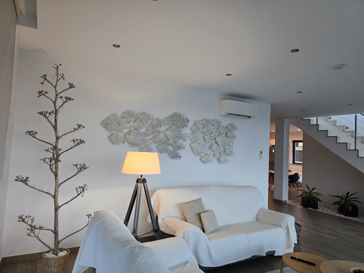 Villa living room sofa with staircase and fish wall art